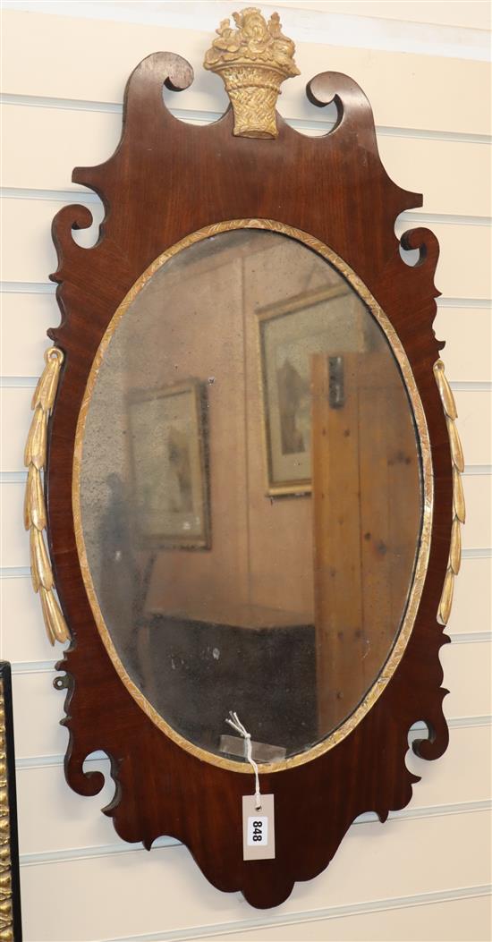 A mahogany and parcel gilt oval fret cut wall mirror H.98cm